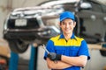 repairman and technician in car garage service in blue uniform