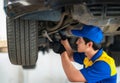 repairman and technician in car garage service in blue uniform