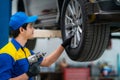 repairman and technician in car garage service in blue uniform