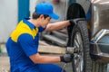 repairman and technician in car garage service in blue uniform