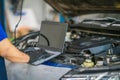 repairman and technician in car garage service in blue uniform