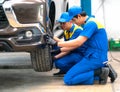 repairman and technician in car garage service in blue uniform