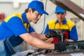 repairman and technician in car garage service in blue uniform