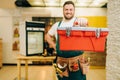 Repairman in uniform holds toolbox, handyman Royalty Free Stock Photo