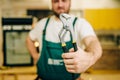 Repairman in uniform holds wrench, handyman Royalty Free Stock Photo