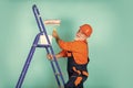 Repairman in uniform. House Painting and Renovation Business. making repair tool. Painter working at construction site Royalty Free Stock Photo