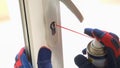 Repairman using lubricate for lock of plastic window