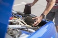 the repairman work with the car, replacing the cylinder intake air filter