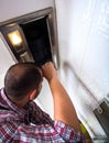 Repairman work on ventilation in the kitchen Royalty Free Stock Photo
