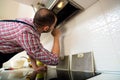 Repairman work on ventilation in the kitchen Royalty Free Stock Photo