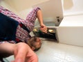 Repairman work on ventilation in the kitchen Royalty Free Stock Photo