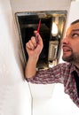 Repairman work on ventilation in the kitchen Royalty Free Stock Photo