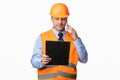 Repairman Worker Talking On Cellphone Holding Folder Standing In Studio Royalty Free Stock Photo