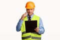 Repairman Worker Talking On Cellphone Holding Folder Standing In Studio Royalty Free Stock Photo
