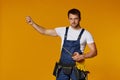 Repairman worker in uniform holding measure tape. Royalty Free Stock Photo