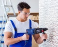 Repairman working with drilling drill perforator Royalty Free Stock Photo