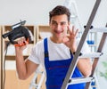 Repairman working with drilling drill perforator Royalty Free Stock Photo