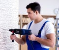 Repairman working with drilling drill perforator Royalty Free Stock Photo