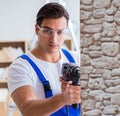 Repairman working with drilling drill perforator Royalty Free Stock Photo