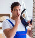 Repairman working with drilling drill perforator Royalty Free Stock Photo