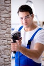 The repairman working with drilling drill perforator Royalty Free Stock Photo