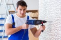 The repairman working with drilling drill perforator Royalty Free Stock Photo