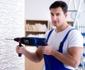 Repairman working with drilling drill perforator Royalty Free Stock Photo