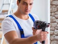 Repairman working with drilling drill perforator Royalty Free Stock Photo