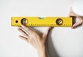 Repairman working with measuring ruler on the wall