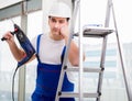 Repairman working with power drill in workshop Royalty Free Stock Photo