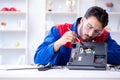 Repairman working in technical support fixing computer laptop tr Royalty Free Stock Photo