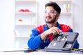 Repairman working in technical support fixing computer laptop tr Royalty Free Stock Photo