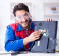 Repairman working in technical support fixing computer laptop tr Royalty Free Stock Photo