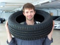 Repairmen automobile mechanic with car tire Royalty Free Stock Photo