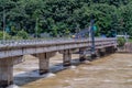 Repairmen working on bridge damaged by flood water