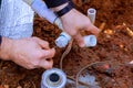 During repairs, technician plumber uses a clear primer on PVC pipes before gluing them