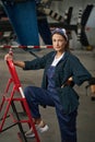 Gorgeous Caucasian woman airframe mechanic standing in hangar Royalty Free Stock Photo