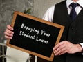 Repaying Your Student Loans sign on the sheet