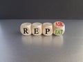 Repeat and repair symbol. Businessman turns a wooden cube and changes the word repeat to repair.