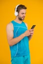 Repeat after video. Athletic man listen music smartphone. Workout playlist. Sport and fitness. Health and wellness