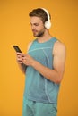 Repeat after video. Athletic man listen music smartphone. Workout playlist. Sport and fitness. Health and wellness