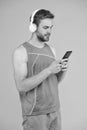 Repeat after video. Athletic man listen music smartphone. Workout playlist. Sport and fitness. Health and wellness