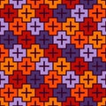 Repeated puzzle mosaic background. Seamless pattern in Halloween traditional colors with simple geometric ornament.