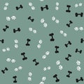 Repeated silhouettes of bones and animal paw prints. Seamless pattern for pets. Royalty Free Stock Photo