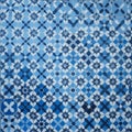 Repeating geometric pattern featuring blue and white tiles arranged in a grid Royalty Free Stock Photo