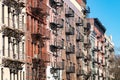 Repeating pattern of fire escapes on colorful old buildings in New York City Royalty Free Stock Photo
