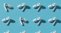 Seamless Pattern of White Wireless Earbuds on a Blue Background Royalty Free Stock Photo