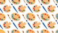 Repeating pattern of paint palettes and brushes, diagonally arra Royalty Free Stock Photo