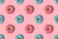 Repeating pattern of pink and blue donuts on a pink background. Flat lay Royalty Free Stock Photo