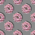 Repeating pattern of pink donuts with marshmallows on a gray background. Flat lay Royalty Free Stock Photo